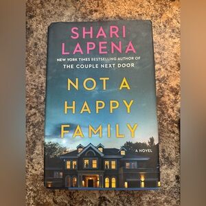 Not a Happy Family by Shari Lapena - Black and Blue Hardcover